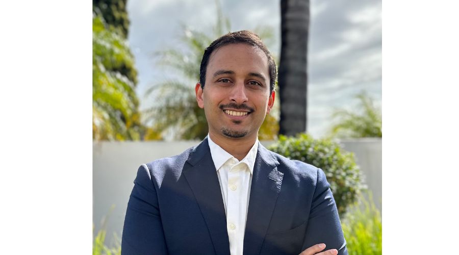 Dr Raj Zaman in a navy suit standing face to camera.